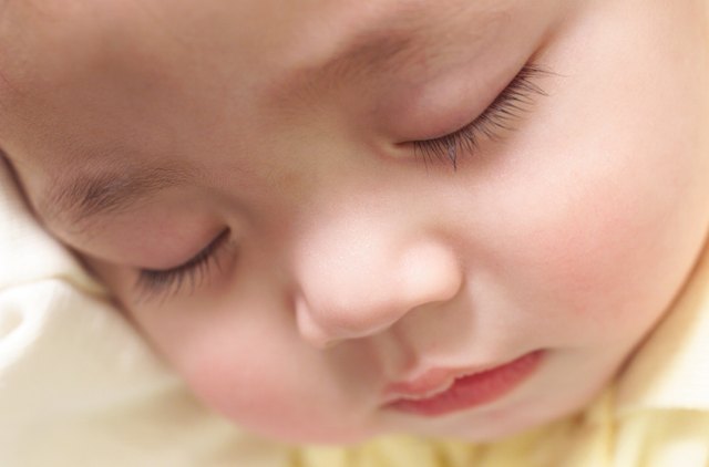 exteme close up on an asian babys face while it sleeps