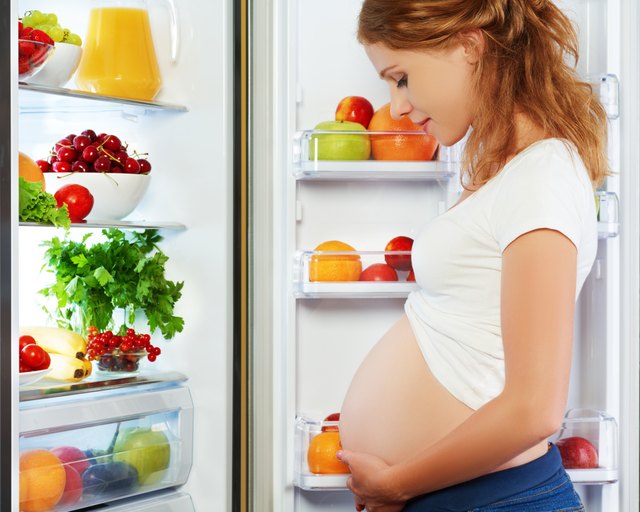 nutrition and diet during pregnancy. Pregnant woman with fruits