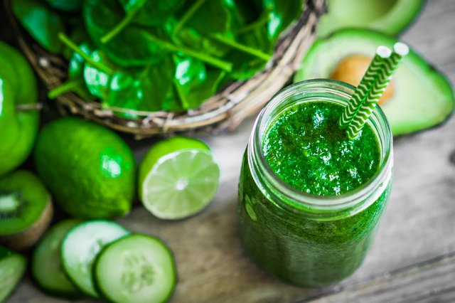 Green smoothie on rustic wooden background