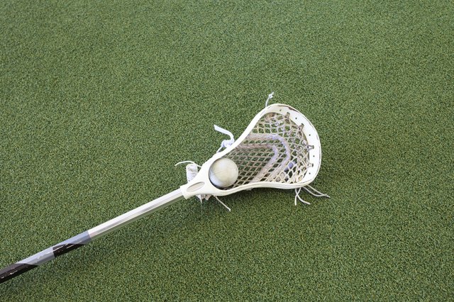 Lacrosse Stick and Ball on Turf