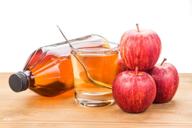 Apple cider vinegar with fresh apple as prop, healthy drink