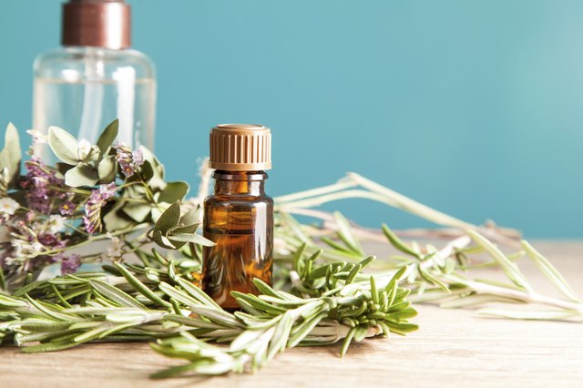 Bottle with aromatic oil and rosemary