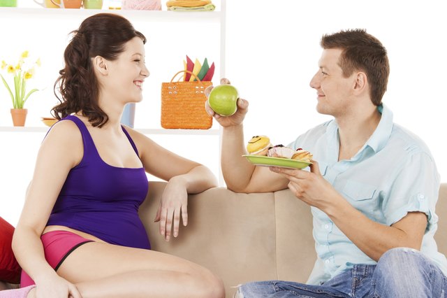 happy expecting parents at home