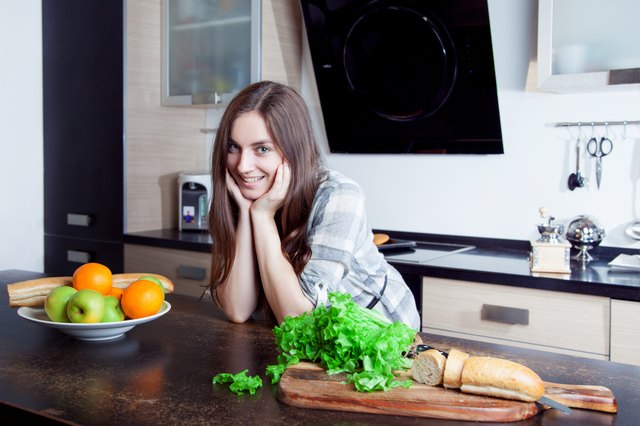 hand of a woman housewife preparing dinner, lettuce on cutting