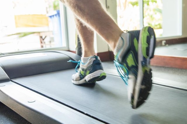 Close up male foot running on treadmill