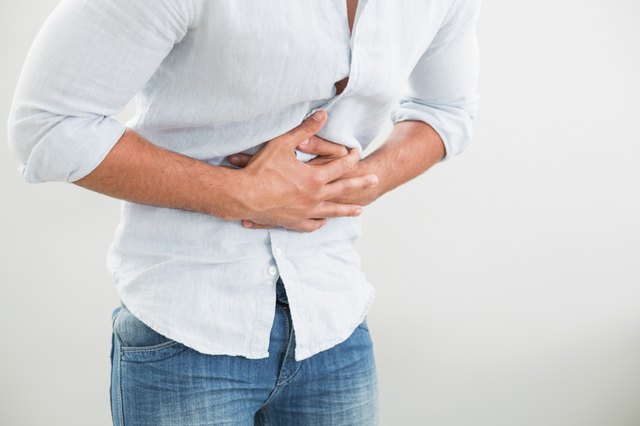 Mid section of man suffering from stomach pain