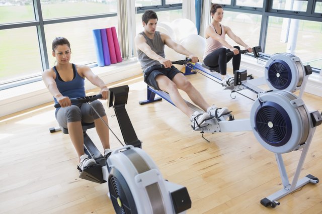 People using rowing machines