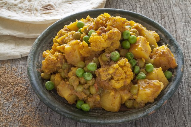Cauliflower and Potato Curry with Green Peas Accompanied with Chapattis.