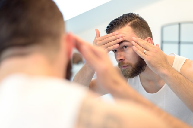 Bearded man checking his complexion