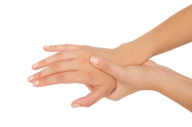 Young woman touching her injured hand