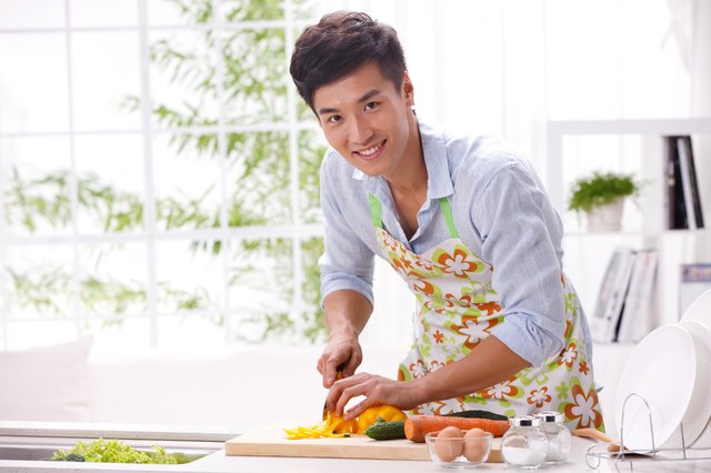 Young man cooking in kitchen
