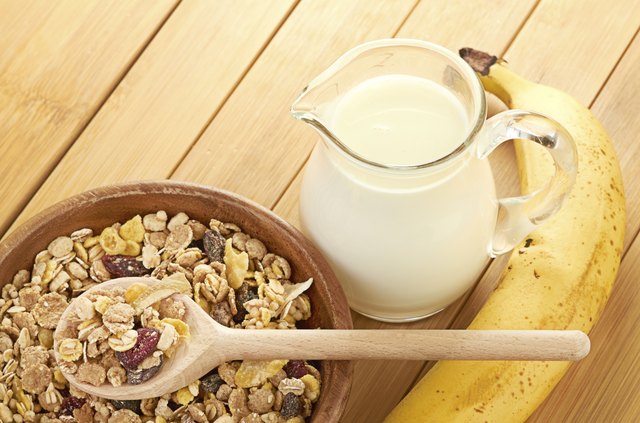 Plate with raw oatmeal on wooden table.