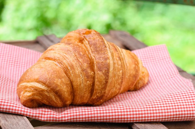 croissant on brown wood table