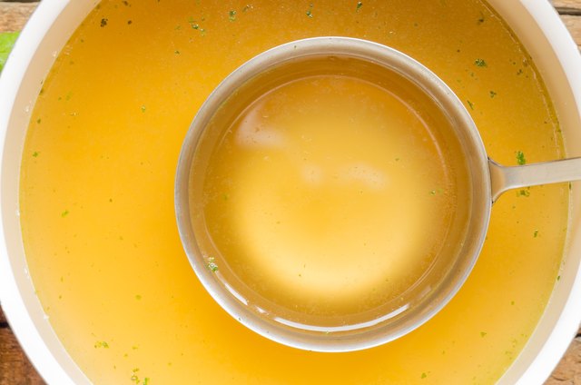 Ladle broth to the pan with the broth background