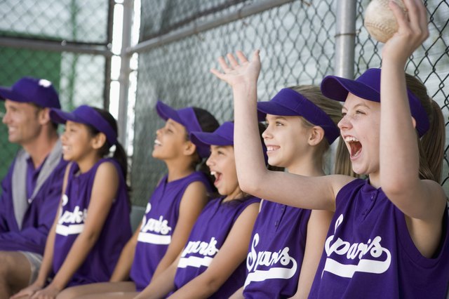 Little league team in dugout cheering
