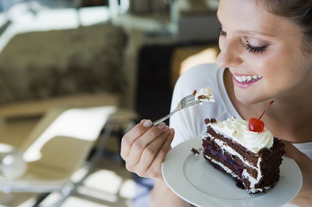 Smiling woman eating cake