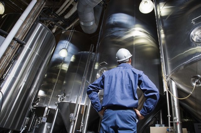 Man looking at brewery vats