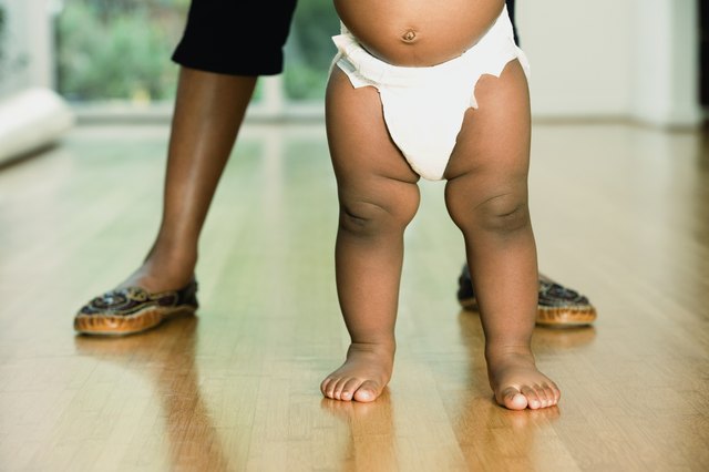 African baby standing with mother