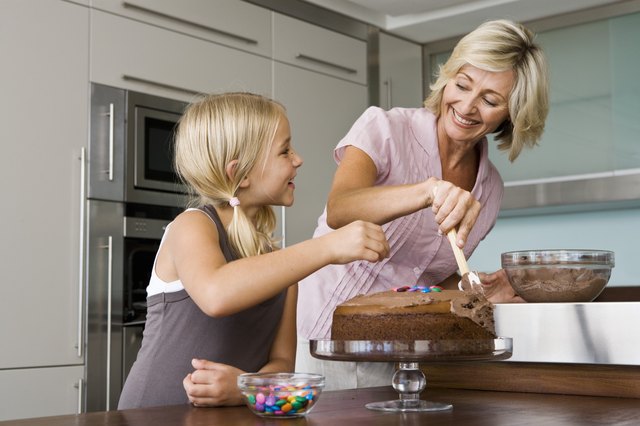 Grandmother and granddaughter baking in kitchen