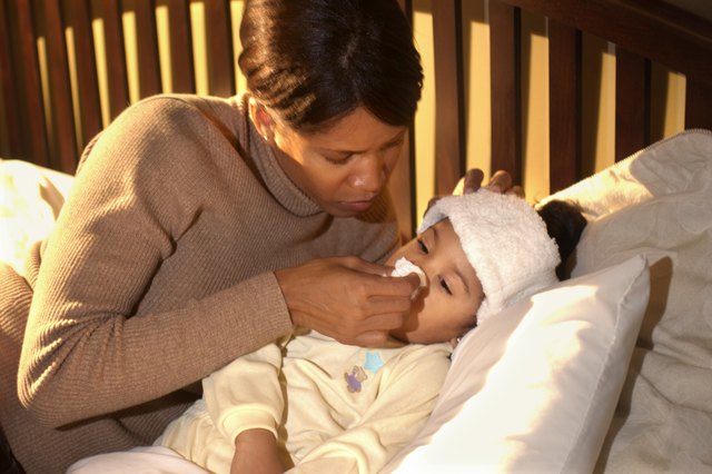 Mother comforting sick daughter