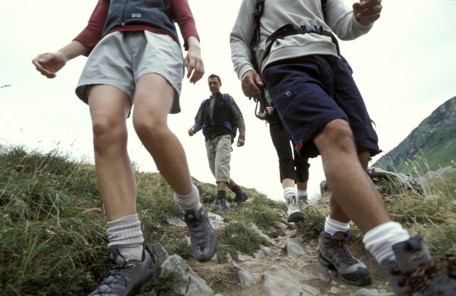 Men and women hiking down mountainside