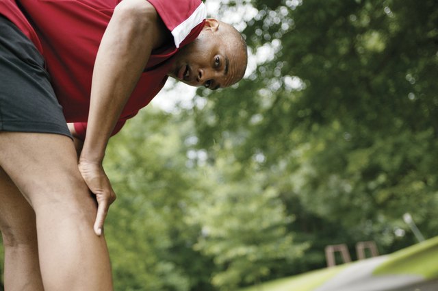 Weary man bending over outdoors