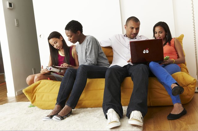 Mixed-race family at home on sofa