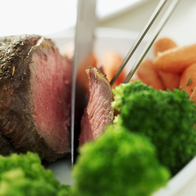 close-up of a person slicing a meat loaf
