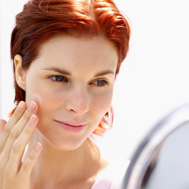 woman applying cream with fingers