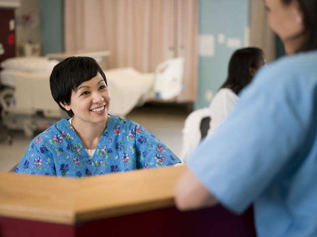 Female nurse and doctor in hospital reception area