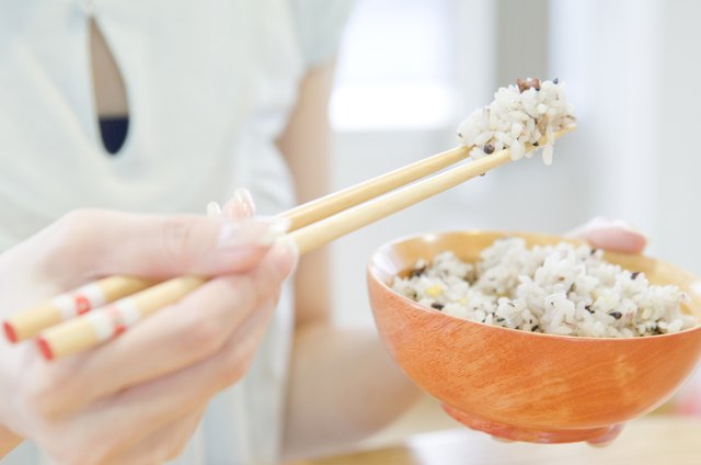 Young Woman Eating Rice