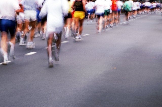 Marathon runners on road, low section
