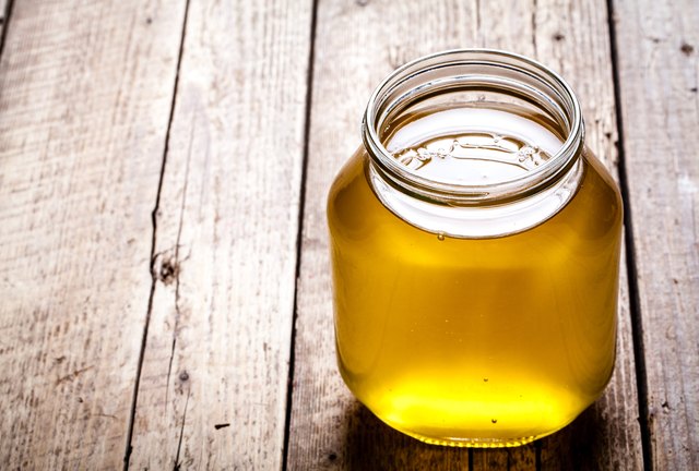 Bowl of honey on wooden table