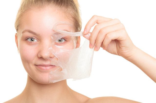 girl removing facial peel off mask
