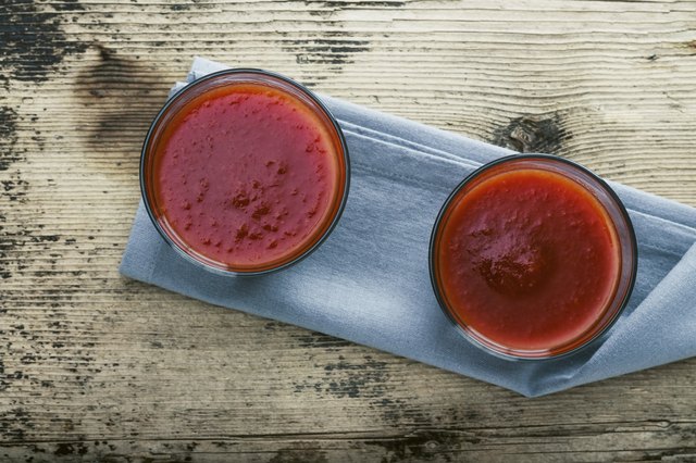 Tomato juice on rustic wooden background