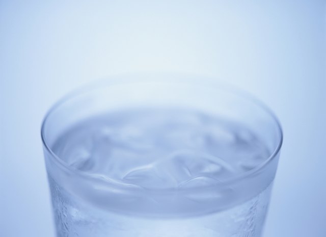 Glass of water, close up, blue background