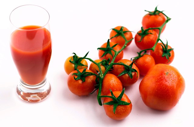 Tomatoes by glass of juice