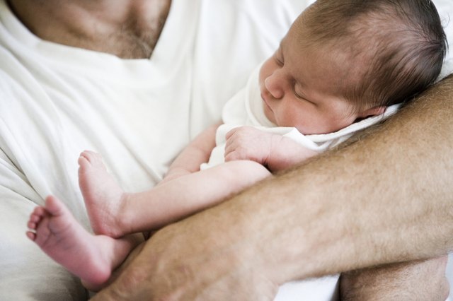 Mid adult man holding his baby