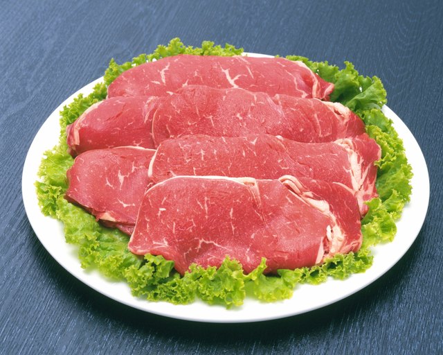 Raw beef on salad, high angle view