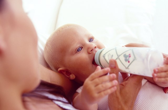 Mother holding feeding baby