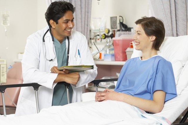Close-up of a male doctor and a female patient smiling