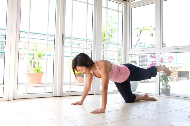 058 Young Asian female doing her leg raise exercis