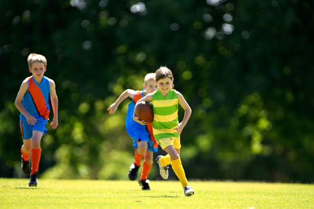 Young female player running with ball