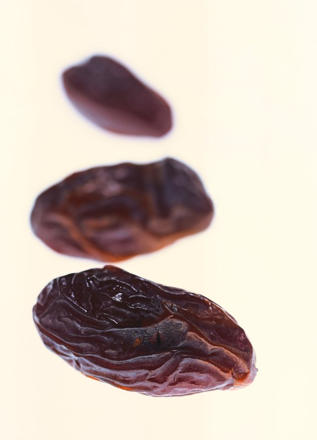 close-up of three dried prunes