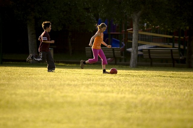 Two kids playing soccer