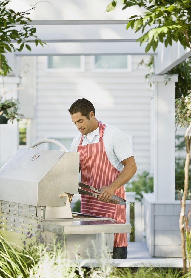 Hispanic man next to barbecue