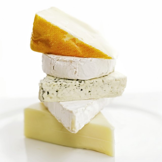 close-up of assorted cheeses piled one on top of the other