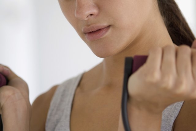 Extreme close-up of teenage girl using resistance band