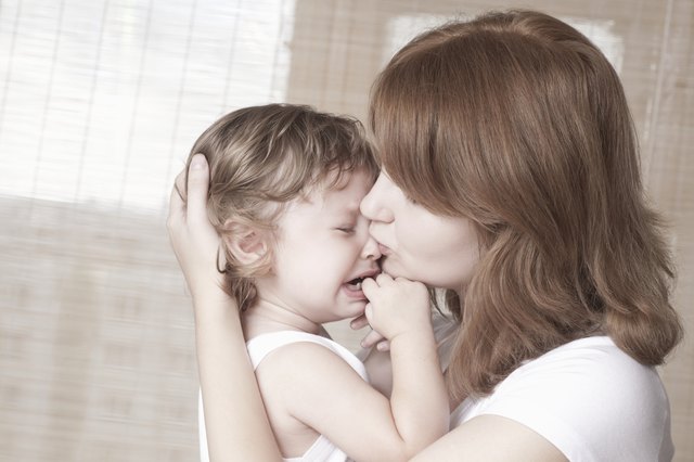 Mother comforts crying child