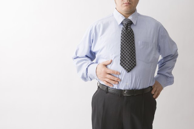 Businessman touching his belly